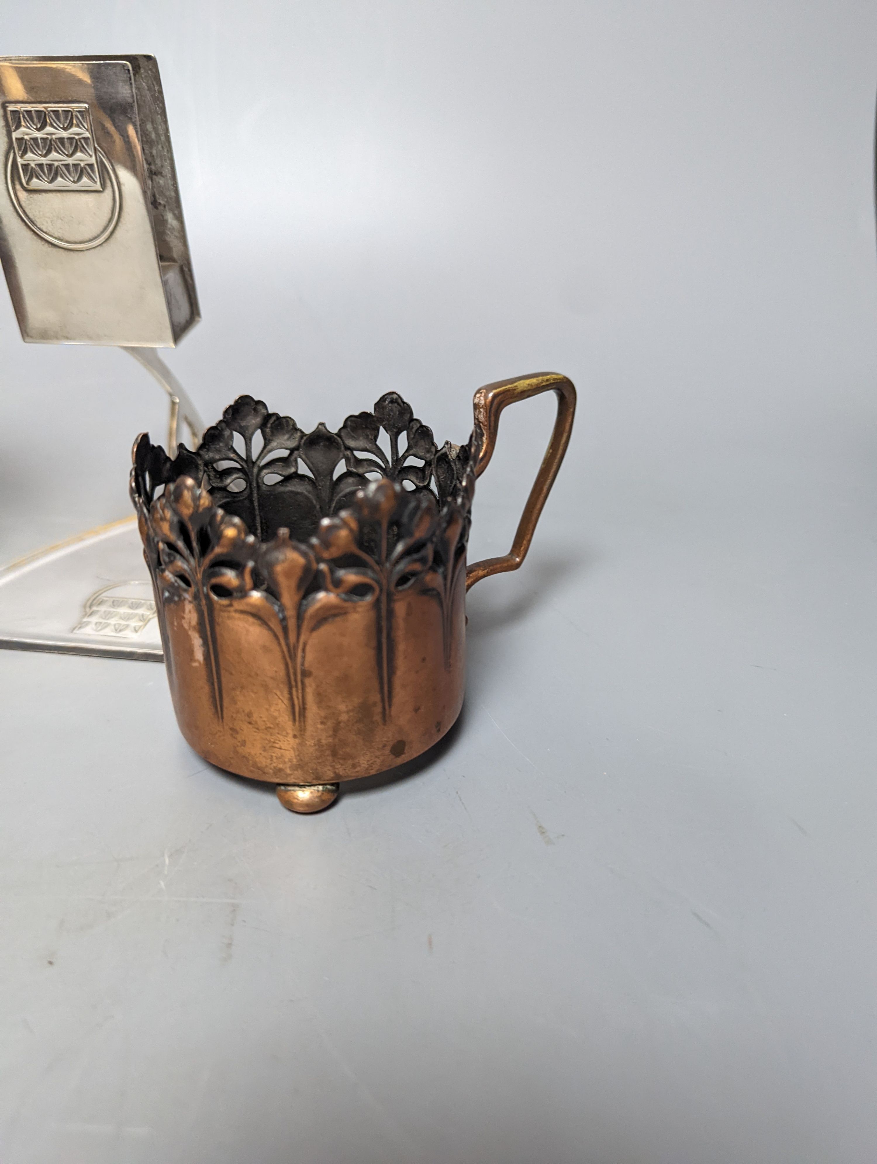 A pair of early WMF copper cup holders, pewter cup holder and a WMF matchbox holder